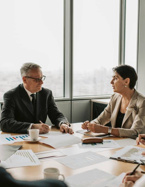 Two people in a meeting discussing taxes.