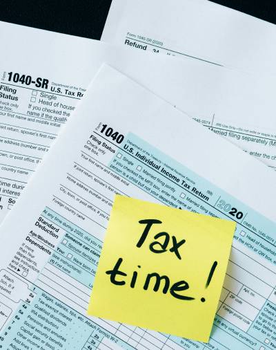 A stack of Tax Documents with a note stating "Tax Time!"